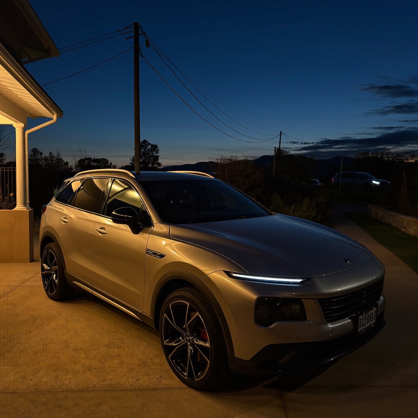 Modern SUV parked on a driveway at dusk
